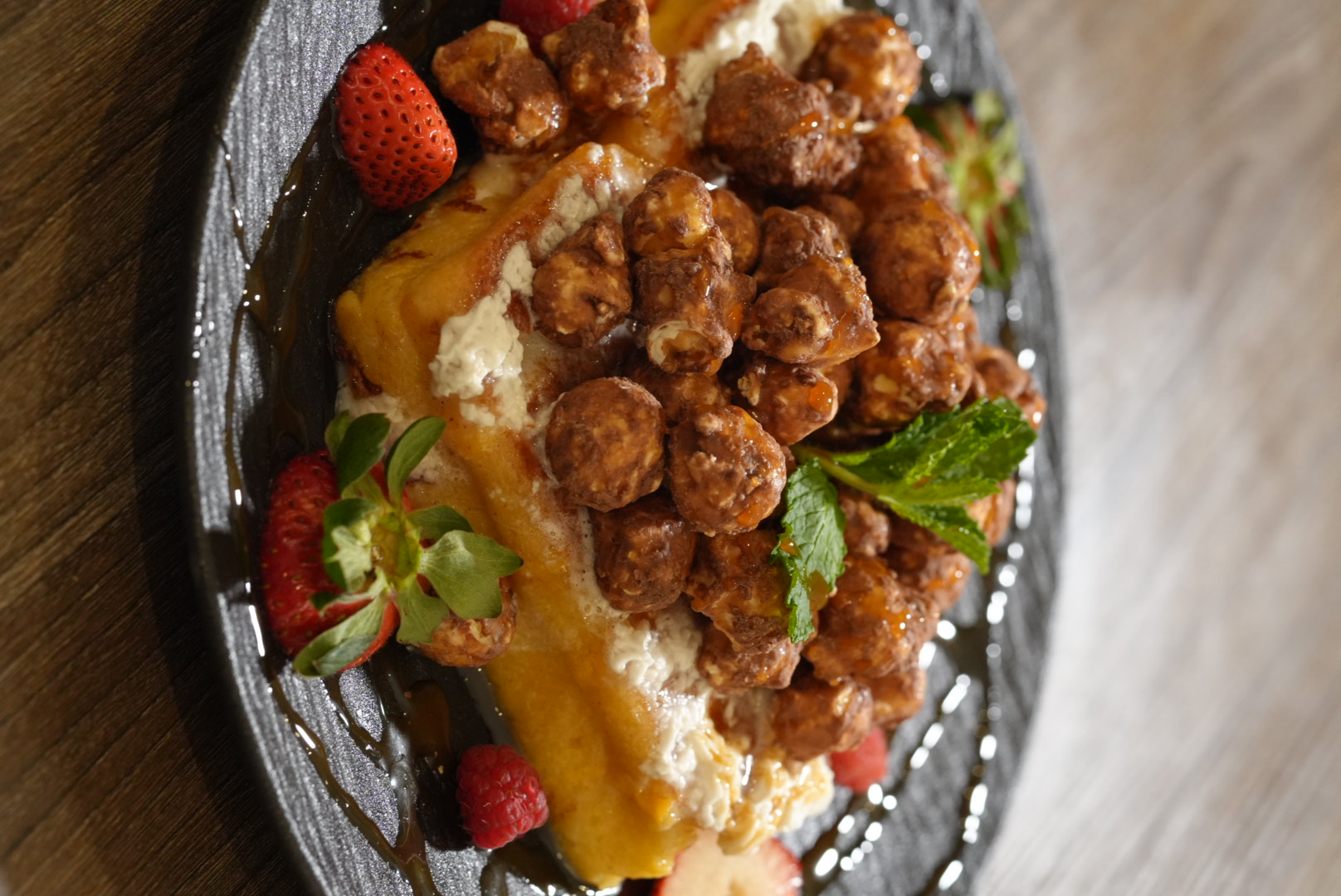 FloJoe's golden waffle layered with chocolate-glazed clusters, fresh berries, and mint