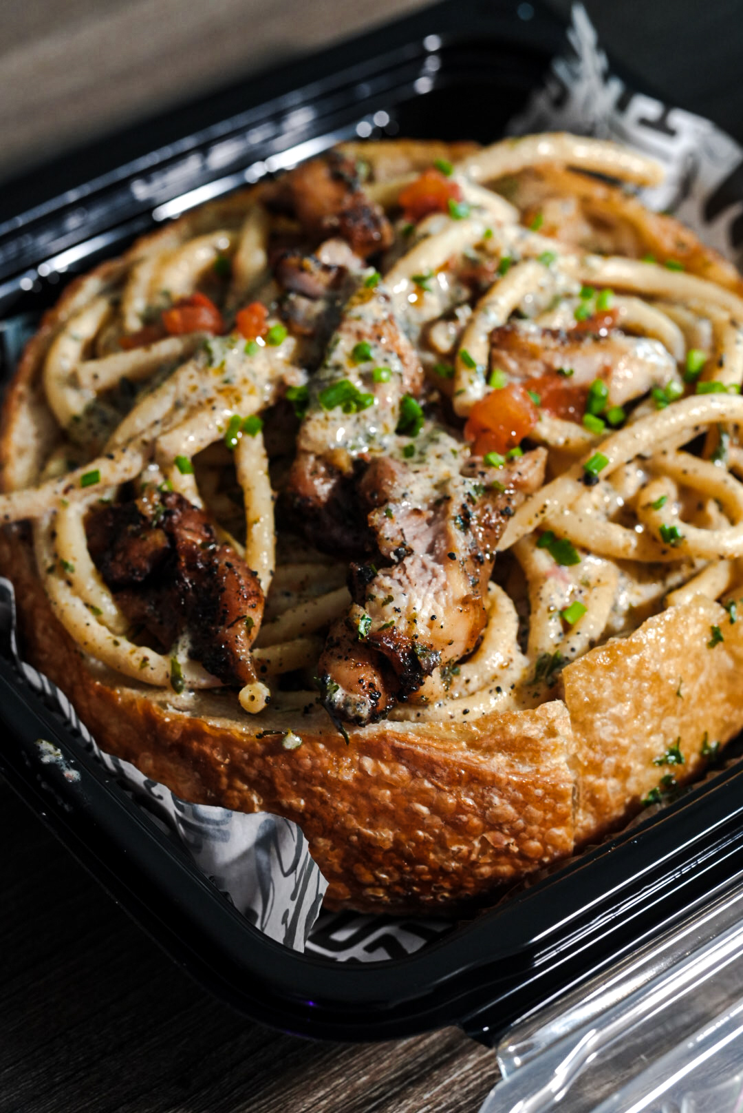 FloJoe's grilled chicken bucatini served inside a sourdough bread bowl