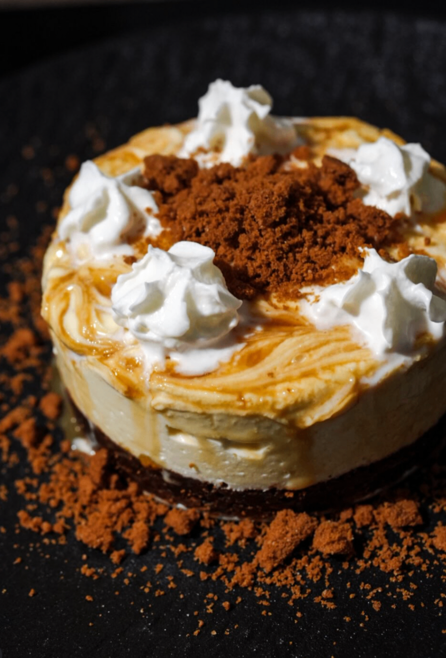 Mini cheesecake topped with whipped cream and cookie crumble