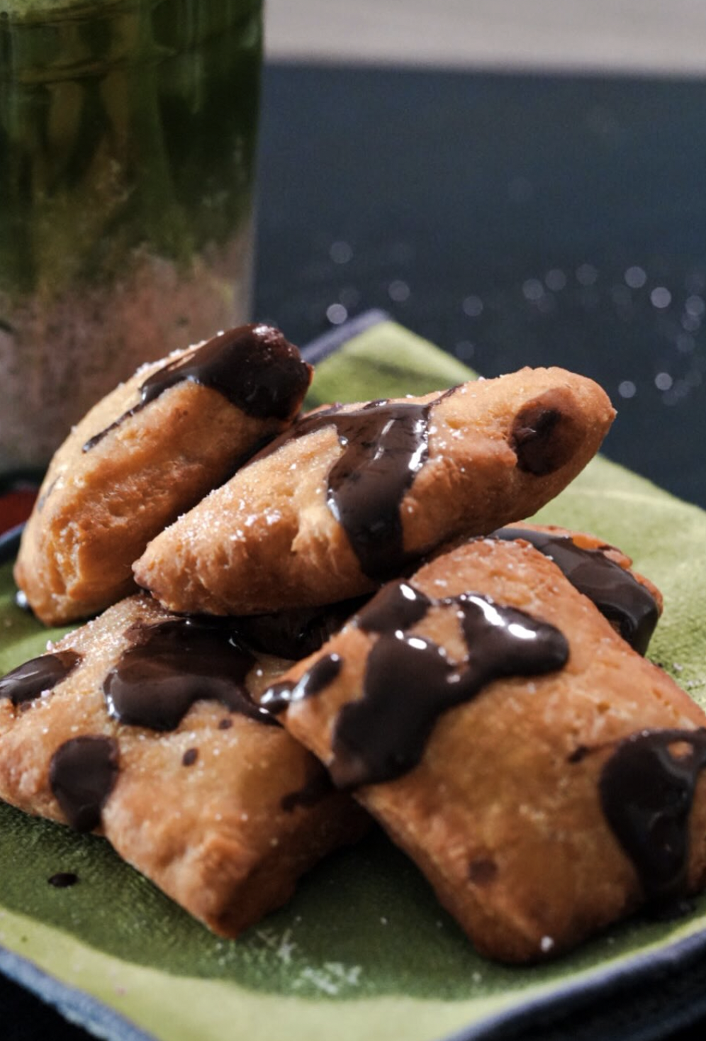 Stacked puff pastries finished with thick dark chocolate drizzle