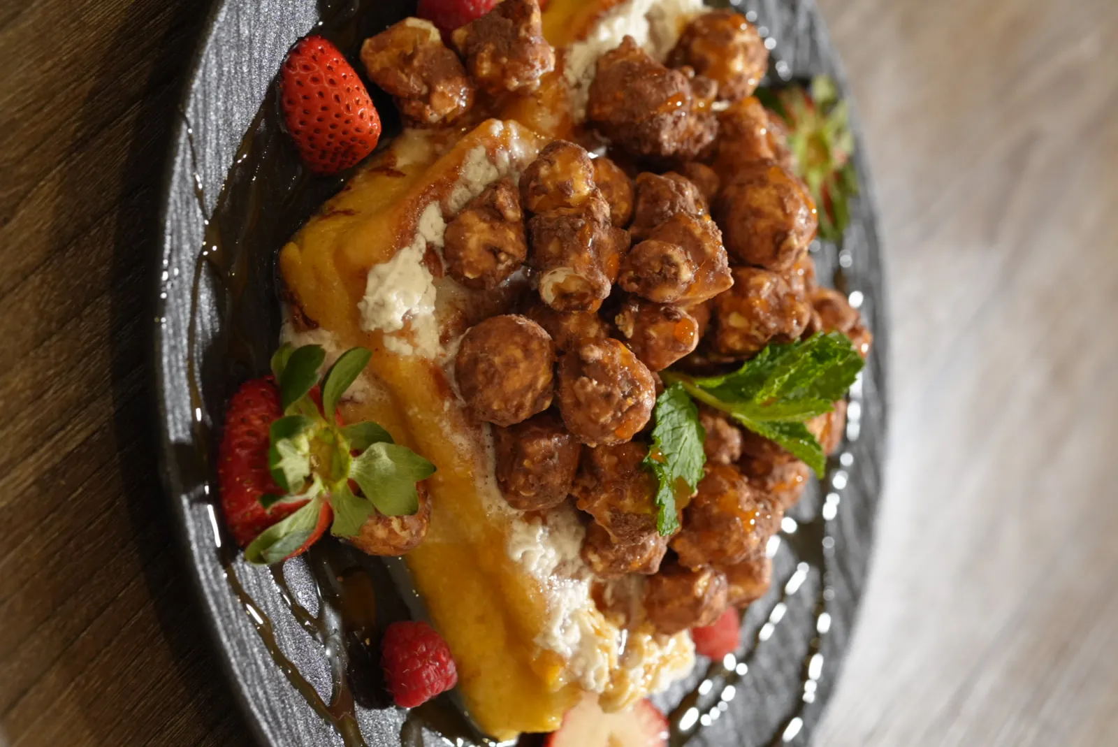 FloJoe's golden waffle layered with chocolate-glazed clusters, fresh berries, and mint